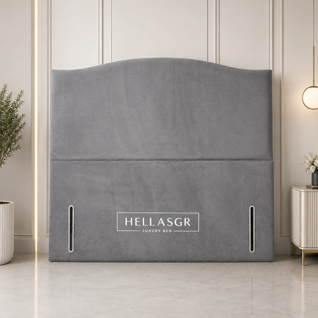 A gray upholstered headboard with a curved top