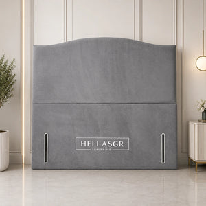 A gray upholstered headboard with a curved top