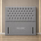 A light gray tufted upholstered headboard
