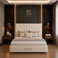 A luxury upholstered bed set in a modern bedroom. The bed features a cream tufted headboard and matching cream base with the brand name 'HELLASGR' visible on the front.