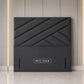 A dark gray upholstered headboard with a geometric diamond quilted pattern 