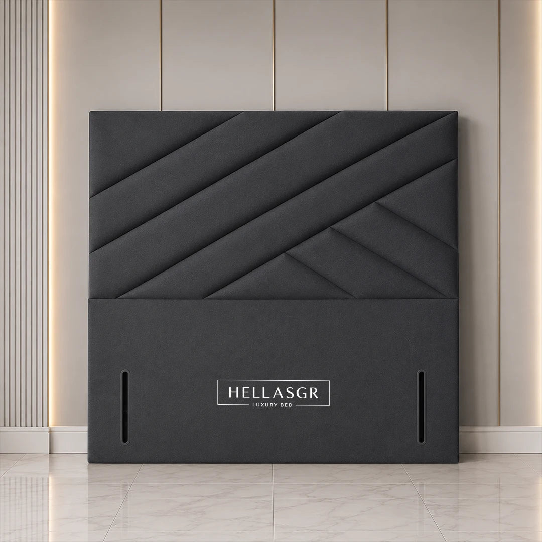 A dark gray upholstered headboard with a geometric diamond quilted pattern 