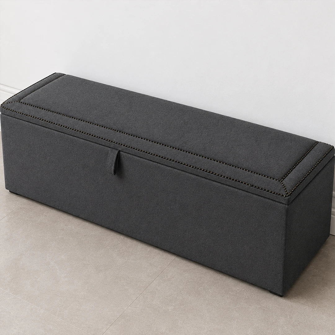 Dark grey upholstered ottoman storage box with lift-up lid