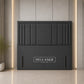 A dark gray upholstered headboard with vertical channel