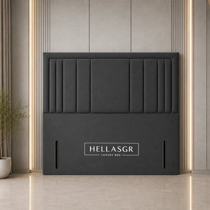 A dark gray upholstered headboard with vertical channel