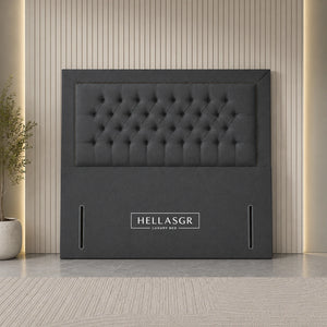 A dark gray upholstered headboard with a tufted button design