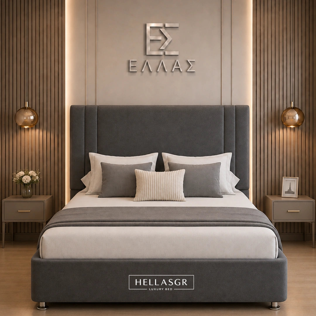 A modern gray upholstered bed with a tall padded headboard and matching footboard, styled in a symmetrical bedroom with wood slat walls, bedside tables, lamps, and decorative pillows. The brand name HELLASGR is visible on the wall and on the bed.