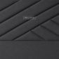 A dark gray upholstered headboard with a geometric diamond quilted pattern 