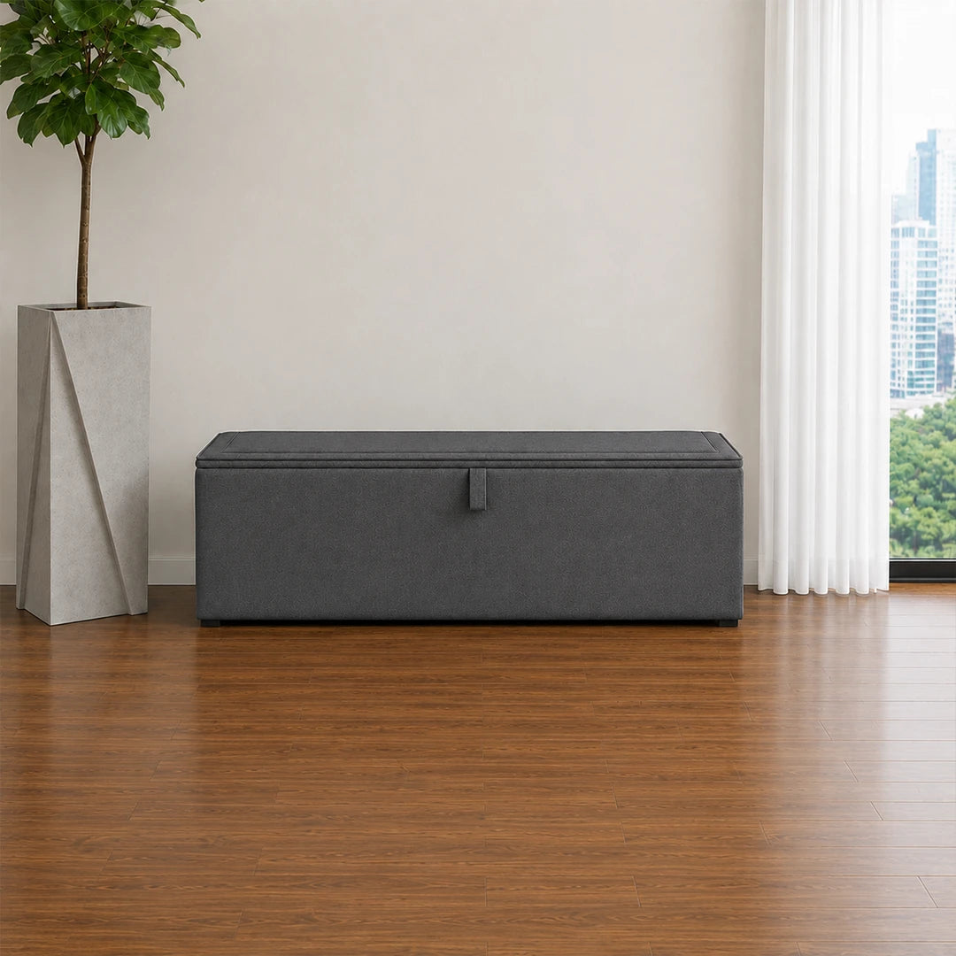Dark grey upholstered ottoman storage box with lift-up lid