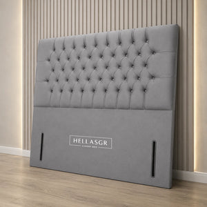 A light gray tufted upholstered headboard