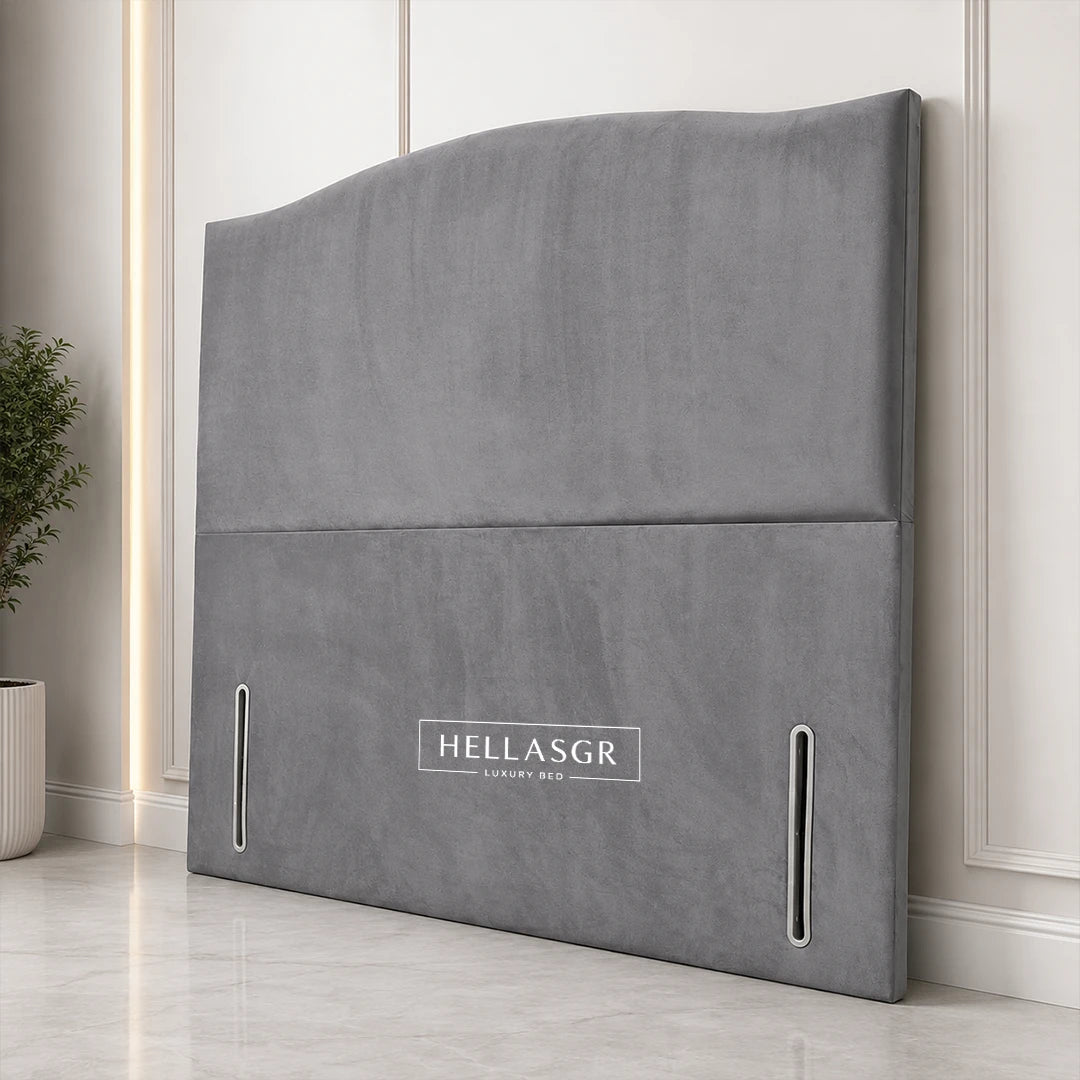 A gray upholstered headboard with a curved top