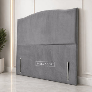 A gray upholstered headboard with a curved top