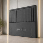 A dark gray upholstered headboard with vertical channel
