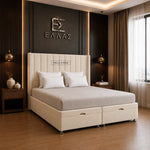 A cream upholstered bed with a tall segmented headboard and storage base