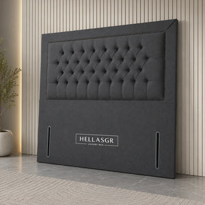 A dark gray upholstered headboard with a tufted button design