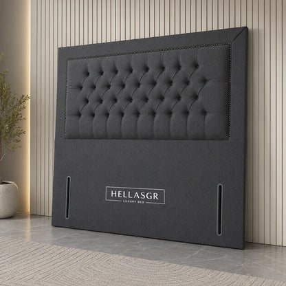 A dark gray upholstered headboard with a tufted button design