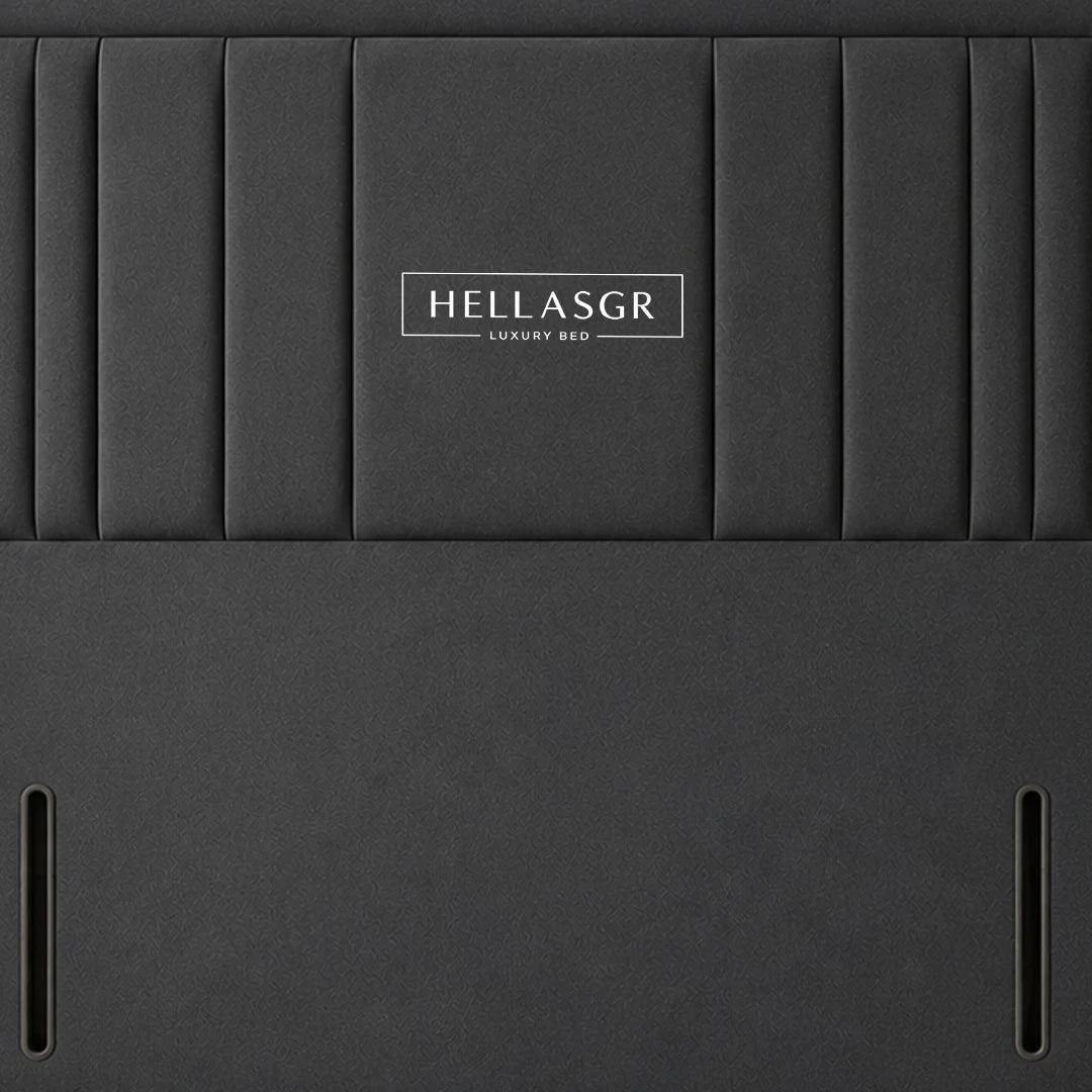 A dark gray upholstered headboard with vertical channel