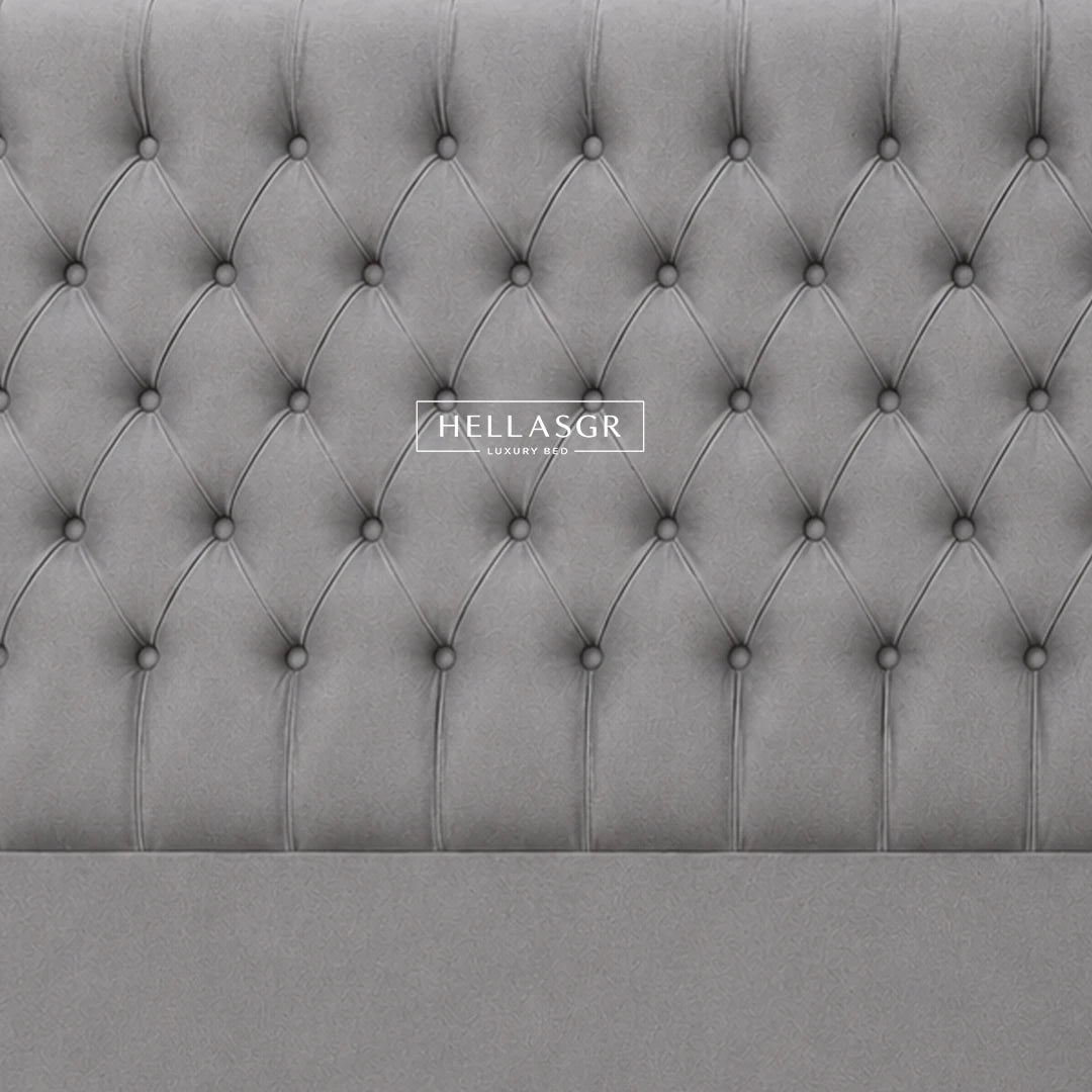 A light gray tufted upholstered headboard