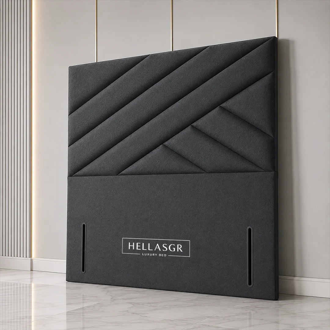 A dark gray upholstered headboard with a geometric diamond quilted pattern 