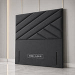 A dark gray upholstered headboard with a geometric diamond quilted pattern 