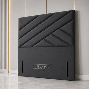 A dark gray upholstered headboard with a geometric diamond quilted pattern 