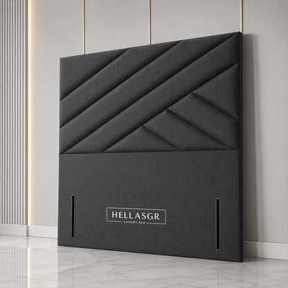 A dark gray upholstered headboard with a geometric diamond quilted pattern 