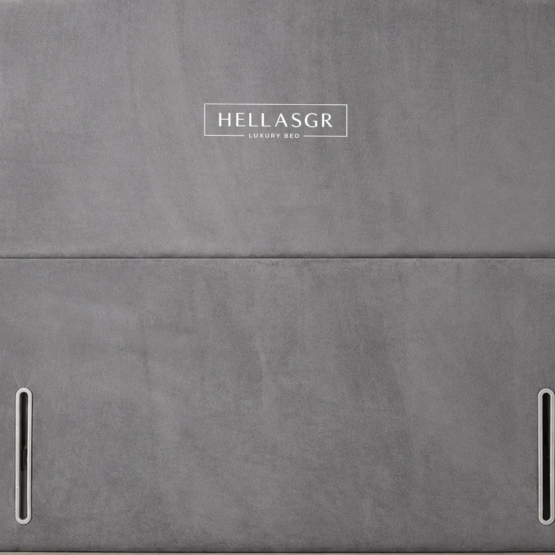 A gray upholstered headboard with a curved top