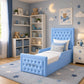 A light blue tufted children's bed with a high headboard and matching footboard