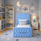 A light blue tufted children's bed with a high headboard and matching footboard