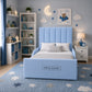 A light blue upholstered children's bed with a tall channel-tufted headboard and matching footboard