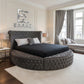 Modern bedroom with a round tufted Diamond Orbit bed and decorative elements.