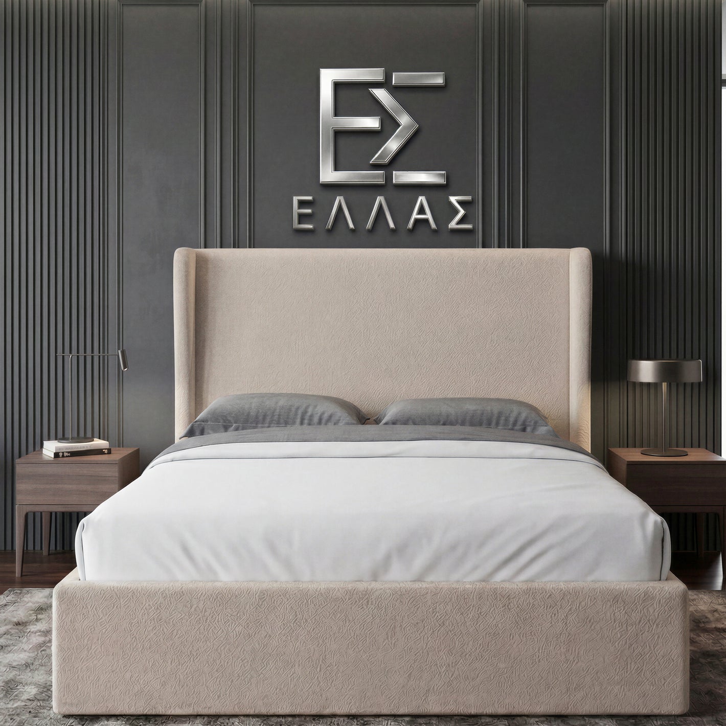 Beige upholstered Marina Elite bed with gray bedding against a dark paneled wall with a logo.