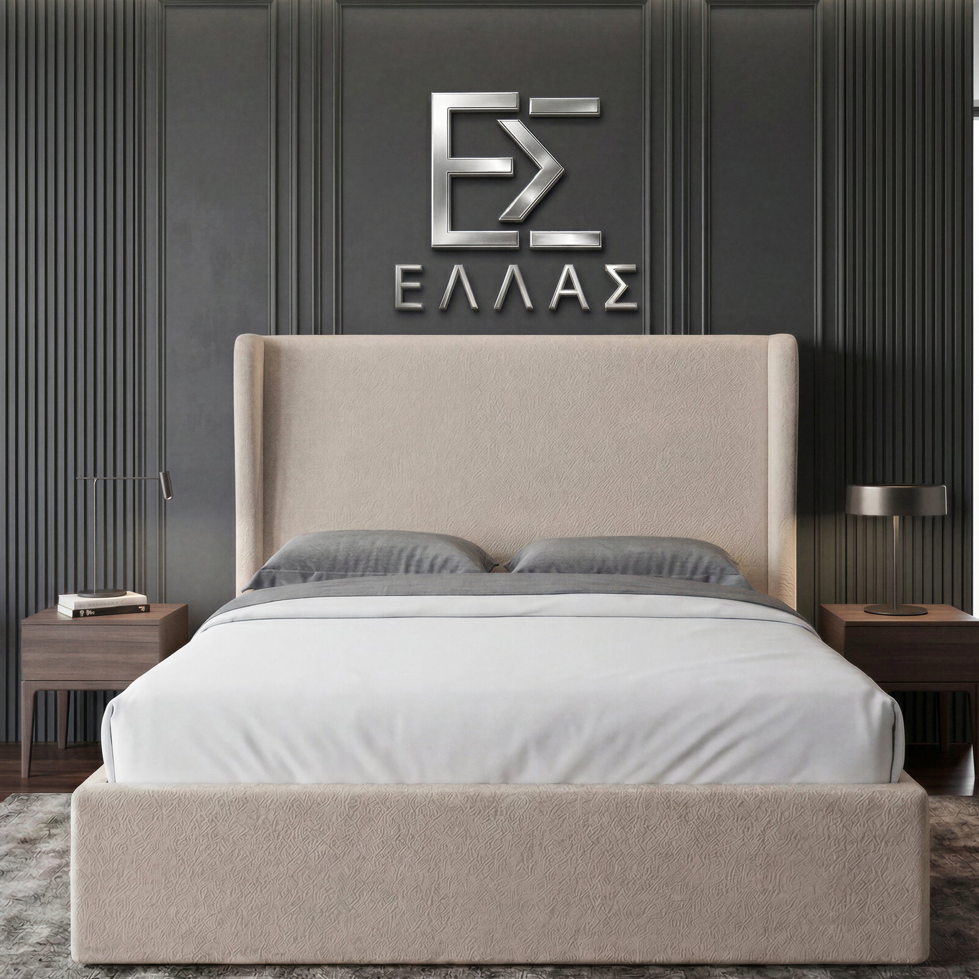 Beige upholstered Marina Elite bed with gray bedding against a dark paneled wall with a logo.