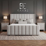 Gray upholstered Newyork Wingback bed in a bedroom setting with 'ELLEA' logo on the wall.