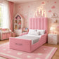 A pink children's bed with a tall channel-tufted headboard and matching footboard,