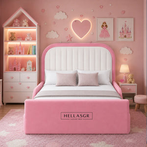 Pink and white upholstered bed frame in a whimsical pink children's bedroom. The bed features a tall rounded headboard