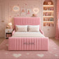 A pink upholstered bed with a tall channel-tufted headboard and matching footboard,
