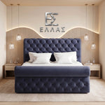 Navy tufted Prisma Royal bed in a modern bedroom with decorative wall and lighting.
