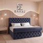 Modern bedroom with a tufted blue Prisma Royal bed and decorative wall letters.