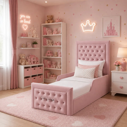 A pink upholstered single bed with a padded headboard and footboard